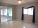 Large bedroom features white tile flooring and natural light at 11354 Sw 138Th Pl, Dunnellon, FL 34432