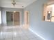 The living room is bright and airy with tile floors and sliding glass doors that lead to the outdoor at 11354 Sw 138Th Pl, Dunnellon, FL 34432