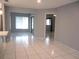 Open living room with white tile floor and entryways at 11354 Sw 138Th Pl, Dunnellon, FL 34432