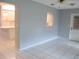 Living room featuring tile flooring and an open view to the kitchen and doorway leading outside at 11354 Sw 138Th Pl, Dunnellon, FL 34432