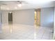 Open-concept living room with light gray walls and tiled floor at 11354 Sw 138Th Pl, Dunnellon, FL 34432