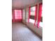 Sun room featuring tile floor and windows with pink curtains at 11354 Sw 138Th Pl, Dunnellon, FL 34432