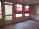 Sunroom featuring tile flooring and windows with pink curtains at 11354 Sw 138Th Pl, Dunnellon, FL 34432