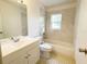 Bathroom with a bathtub, toilet and updated vanity at 12467 Se 62Nd Ave, Belleview, FL 34420