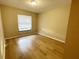 Bright bedroom with window and wood-look floors at 12467 Se 62Nd Ave, Belleview, FL 34420