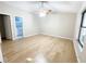 Bright bedroom with wood-look floors and ensuite bathroom access at 12467 Se 62Nd Ave, Belleview, FL 34420