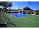 Community basketball court is fenced and well maintained with basketball hoops on a sunny day at 16331 Sw 12Th Ter, Ocala, FL 34473