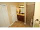 Bathroom featuring granite countertop, tiled shower, and a linen closet at 16331 Sw 12Th Ter, Ocala, FL 34473