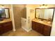 Bathroom featuring dual sinks, granite countertops and tiled walk-in shower at 16331 Sw 12Th Ter, Ocala, FL 34473