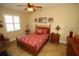 Cozy bedroom featuring a wood bed frame, ceiling fan, and neutral wall color at 16331 Sw 12Th Ter, Ocala, FL 34473