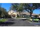 Exterior view of the community clubhouse with ample parking and mature landscaping in a well maintained area at 16331 Sw 12Th Ter, Ocala, FL 34473