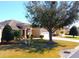 Well-maintained house with a large tree in front yard on a sunny day at 16331 Sw 12Th Ter, Ocala, FL 34473