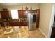 Kitchen area featuring granite countertops, stainless steel fridge, and dark cabinets at 16331 Sw 12Th Ter, Ocala, FL 34473