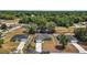 Beautiful aerial view of the home features a green exterior, an attached garage, and a long driveway at 176 Pine Crse, Ocala, FL 34472