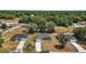 The aerial view of the home shows the green exterior, the drive, and the surrounding greenery at 176 Pine Crse, Ocala, FL 34472