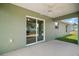 Covered back patio with ceiling fan and view of backyard at 176 Pine Crse, Ocala, FL 34472