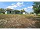 Expansive backyard features a grassy area and an extended view of the neighborhood homes at 176 Pine Crse, Ocala, FL 34472