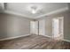 Spacious main bedroom features tray ceilings, wood-look floors, and multiple doorways at 176 Pine Crse, Ocala, FL 34472