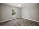 Cozy bedroom with wood-look flooring, a ceiling fan, and a bright window with a view at 176 Pine Crse, Ocala, FL 34472