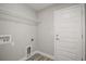 The laundry room with shelving and a door to the exterior is practical and well-lit at 176 Pine Crse, Ocala, FL 34472