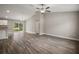 Spacious living room with hardwood floors, a modern ceiling fan, and natural light at 176 Pine Crse, Ocala, FL 34472