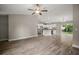 Open-concept living room with kitchen, stainless appliances, and sliding glass door to patio at 176 Pine Crse, Ocala, FL 34472
