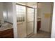 Bathroom with enclosed shower with glass blocks and double sink vanity at 6688 Sw 113Th Pl, Ocala, FL 34476