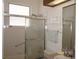 This bathroom features a glass shower enclosure and white tile, creating a clean and functional space at 6688 Sw 113Th Pl, Ocala, FL 34476
