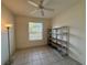 This bedroom features a ceiling fan, tile floors, and a floor lamp at 6688 Sw 113Th Pl, Ocala, FL 34476