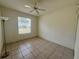 Bedroom with tile floors, ceiling fan, and a window with blinds at 6688 Sw 113Th Pl, Ocala, FL 34476