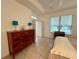 Bright bedroom with natural light, tile floor, and large dresser at 6688 Sw 113Th Pl, Ocala, FL 34476