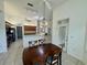 Dining area with a chandelier, view to the kitchen, and seating for Gathering and guests at 6688 Sw 113Th Pl, Ocala, FL 34476