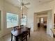Light-filled dining space offering backyard views, a chandelier, and convenient access to other rooms at 6688 Sw 113Th Pl, Ocala, FL 34476