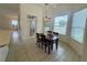 Cozy dining area with a chandelier, views of the outdoors, and space for Gathering gatherings at 6688 Sw 113Th Pl, Ocala, FL 34476