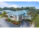 Exterior shot of community center with a blue roof and lush landscaping at 6688 Sw 113Th Pl, Ocala, FL 34476