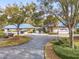Exterior view of a community clubhouse with a vibrant landscape and ample parking at 6688 Sw 113Th Pl, Ocala, FL 34476