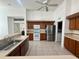 The kitchen features wood cabinets, tile floors, stainless steel appliances, and modern lighting at 6688 Sw 113Th Pl, Ocala, FL 34476