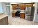Updated kitchen featuring stainless steel appliances, oak cabinetry, and tile floors at 6688 Sw 113Th Pl, Ocala, FL 34476