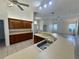 Kitchen with an expansive countertop, stainless steel sink, and wood cabinets at 6688 Sw 113Th Pl, Ocala, FL 34476