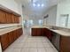 The kitchen features wood cabinets, tile floors, and an open floor plan at 6688 Sw 113Th Pl, Ocala, FL 34476