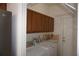Functional laundry room with washer, dryer, utility sink, and cabinets for storage at 6688 Sw 113Th Pl, Ocala, FL 34476