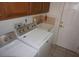 The laundry room features tile floors, modern appliances, and storage at 6688 Sw 113Th Pl, Ocala, FL 34476