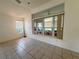 Well-lit living area featuring neutral colors, large windows, and tile flooring throughout at 6688 Sw 113Th Pl, Ocala, FL 34476