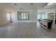 Spacious living room with tile flooring flowing into an open kitchen and dining area at 6688 Sw 113Th Pl, Ocala, FL 34476