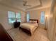 Relaxing main bedroom with natural lighting, neutral tones, and comfortable furnishing at 6688 Sw 113Th Pl, Ocala, FL 34476