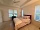 Calm main bedroom with natural light, a ceiling fan, and tiled floors for comfort at 6688 Sw 113Th Pl, Ocala, FL 34476