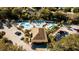 Aerial view of a community with multiple pools, a spa, palm trees, and parking at 6688 Sw 113Th Pl, Ocala, FL 34476