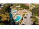 Aerial view of a community pool with a tropical landscape, lounge chairs, and parking at 6688 Sw 113Th Pl, Ocala, FL 34476