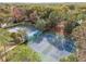 Overhead view featuring well-maintained tennis courts, seating, and a glimpse of the surrounding verdant greenery at 6688 Sw 113Th Pl, Ocala, FL 34476