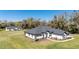 Single-story home boasts a dark gray roof, white siding, black trim, and inviting curb appeal at 1725 W Hwy 329, Citra, FL 32113